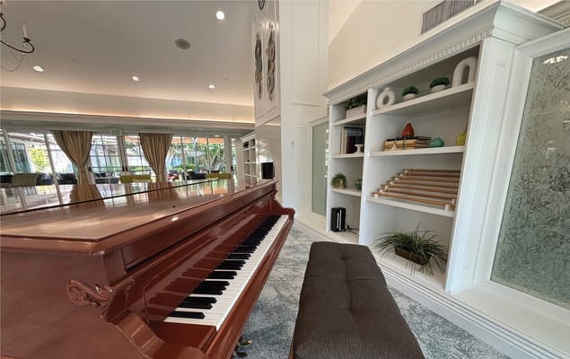Interior view of a bright common area with a piano