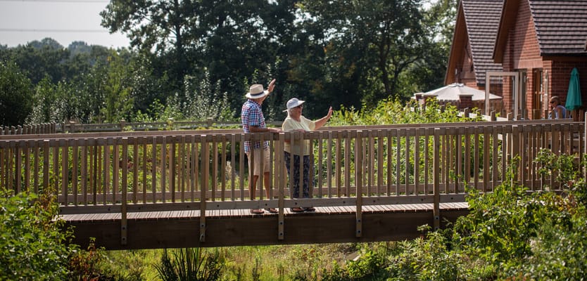 Two residents enjoying the outdoor area on a bridge
