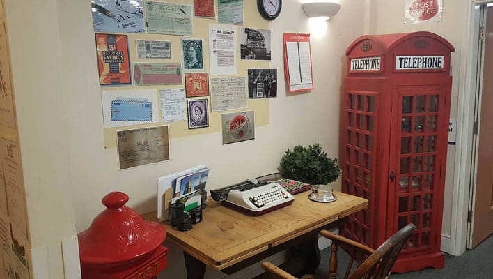 Interior room with vintage decor including a typewriter and telephone booth