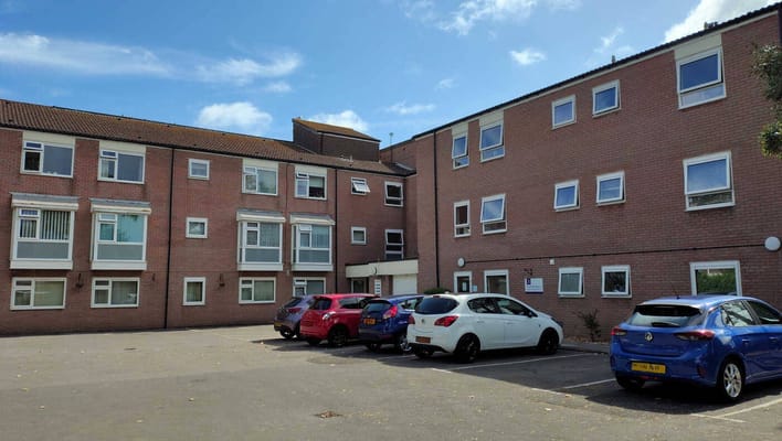 Exterior view of the facility with parking area