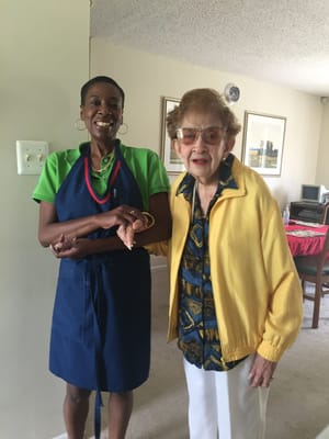 Staff member with a resident in a bright room