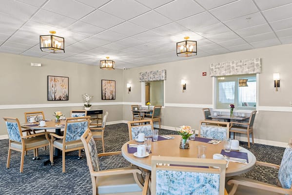 Dining room with tables and chairs set for meals