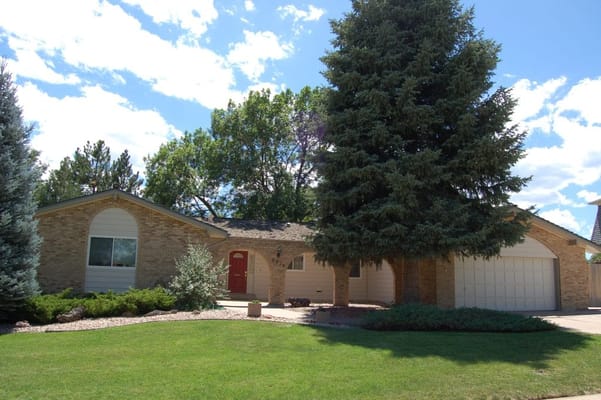 Exterior view of a single-story care facility with garden