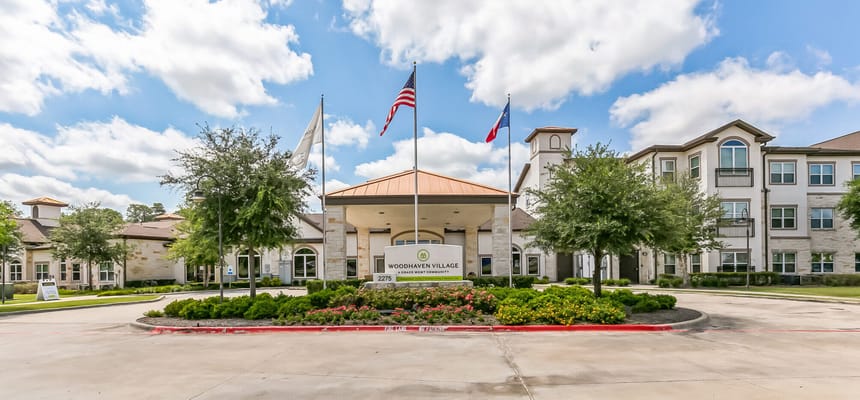 Exterior view of Woodhaven Village with flags