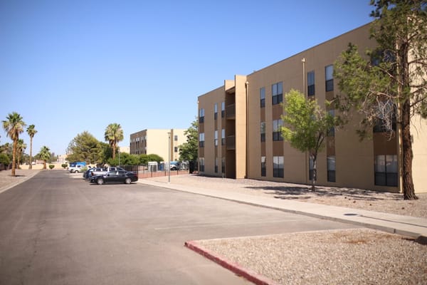 Exterior view of a senior living facility with palm trees