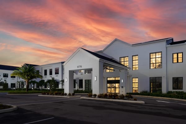 Exterior view of American House Boynton Beach with sunset