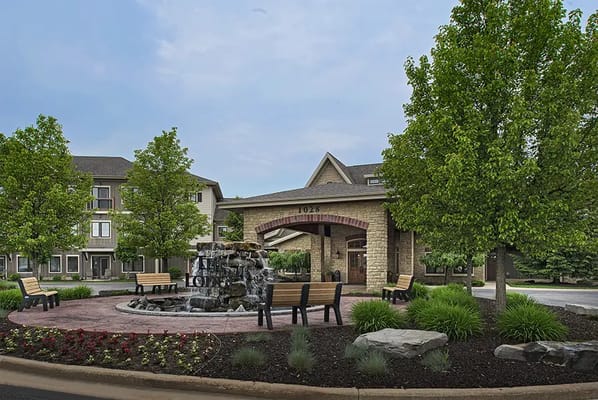 Exterior view of a senior living facility with landscaping