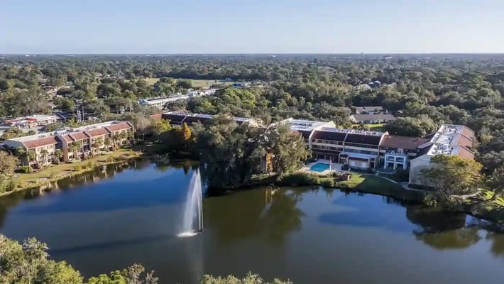 Aerial view of a senior living community with a lake