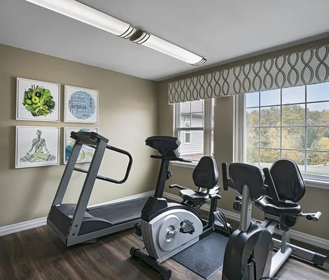 Fitness room with exercise equipment and artwork
