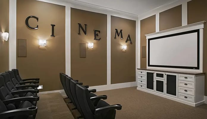 Interior of a cinema room with seating and a screen