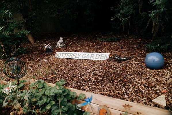 Sign for a butterfly garden with decorations