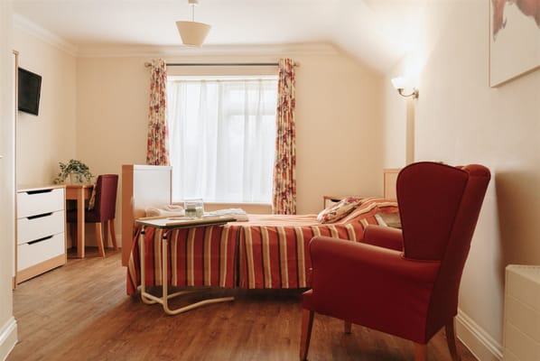 Cozy private room with a bed and seating area