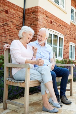 Elderly couple enjoying each other's company on a bench