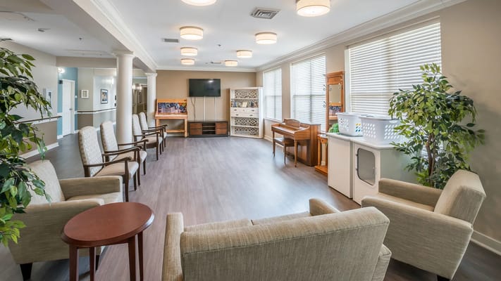 Bright common area with seating and piano