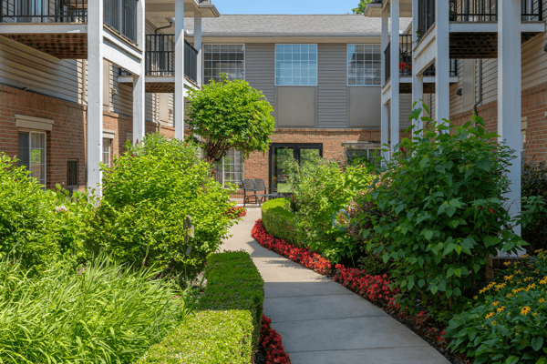 Lush garden pathway surrounded by buildings