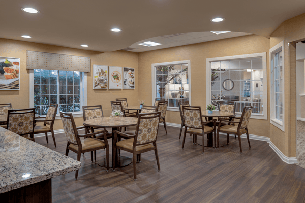 Bright dining room with tables set for meals