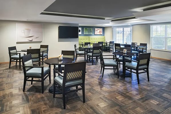 Dining area in a senior living facility with empty tables