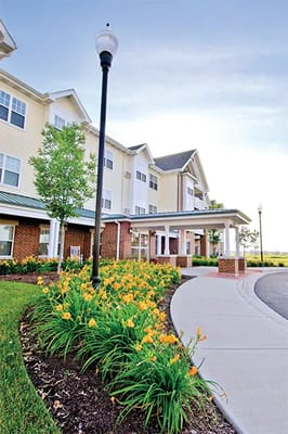 Exterior view of assisted living facility with landscaping