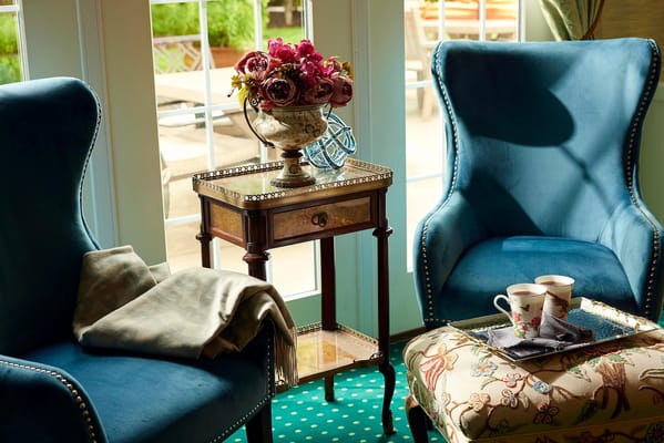 Cozy seating area with blue chairs and floral centerpiece
