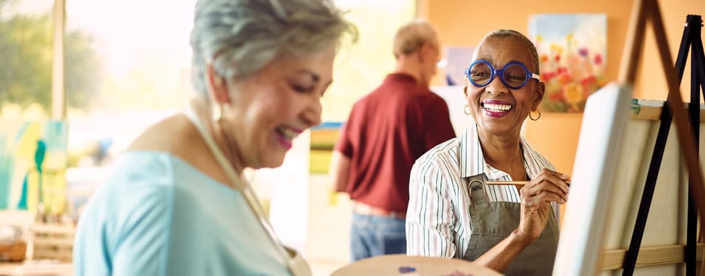 Residents enjoying a painting activity in a bright room