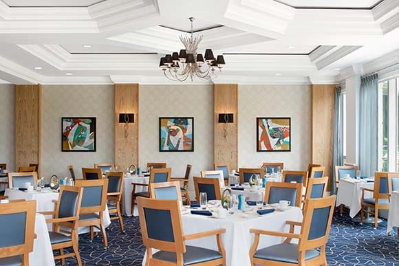 Elegant dining room with table settings and artwork