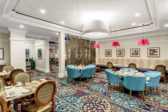 Dining room with colorful decor and tables set for meals.