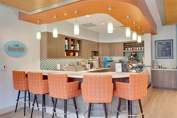 A stylish café interior with orange bar stools and modern decor