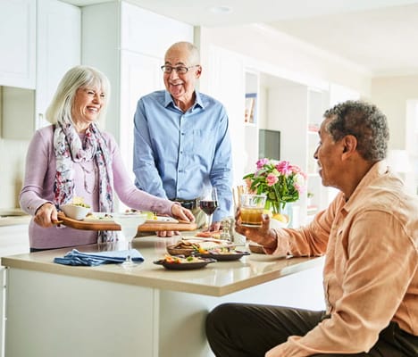 Residents enjoying a meal together in a bright kitchen