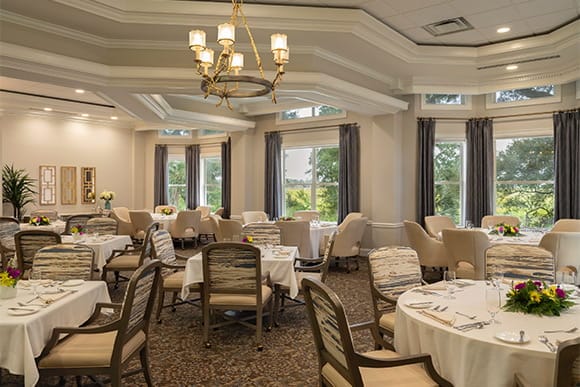 Elegant dining room setup with flowers and tables