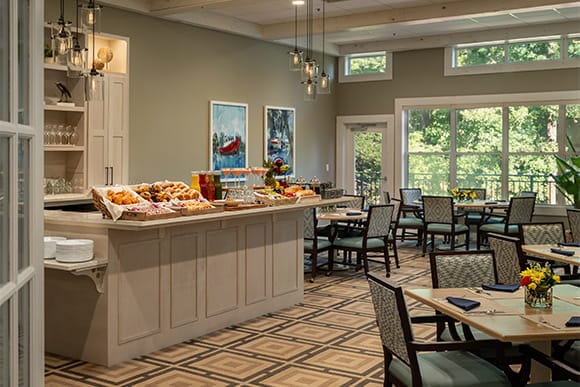 Bright dining room with a buffet of pastries and flowers