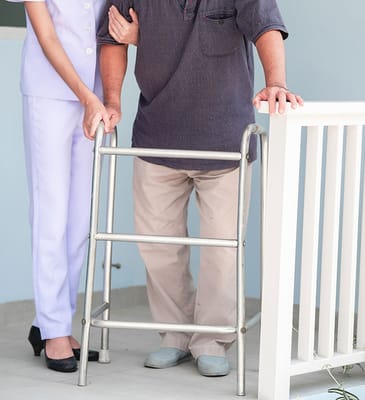 Caregiver assisting a resident with a walker