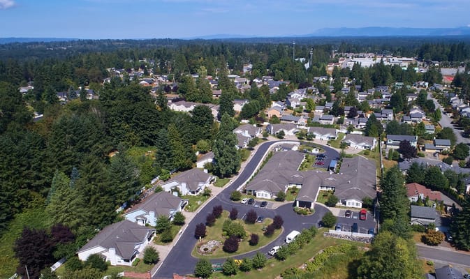 Aerial view of a senior living community surrounded by trees
