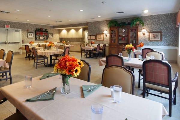 Dining room set for a meal with floral arrangements