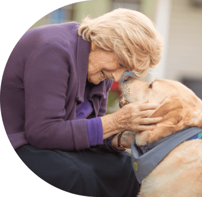 Resident interacting with a dog in a warm moment