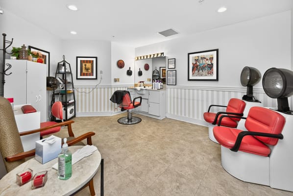 Hair salon interior with red chairs and styling equipment