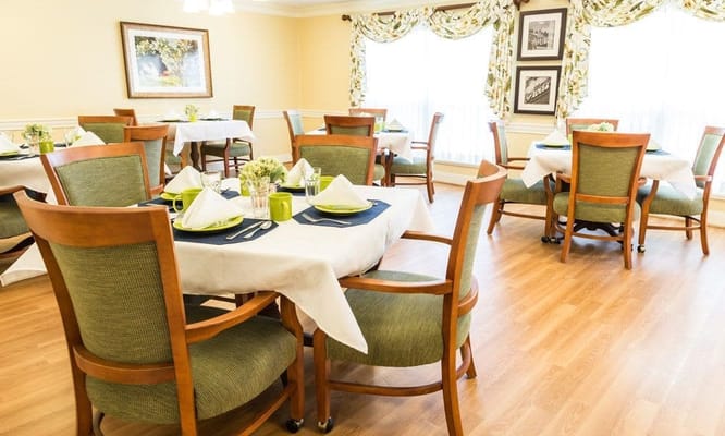 Interior view of a dining room with tables set for meals