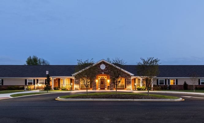 Building exterior of a senior living facility at dusk