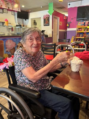 Resident enjoying ice cream in a café setting