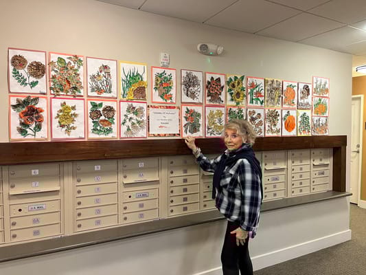 A resident showcasing art in a common area