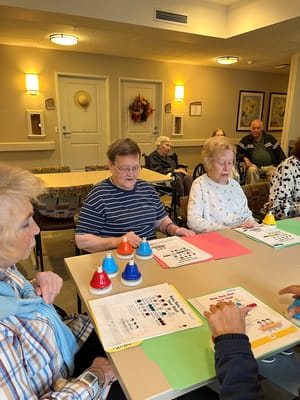 Residents engaged in a group activity at tables