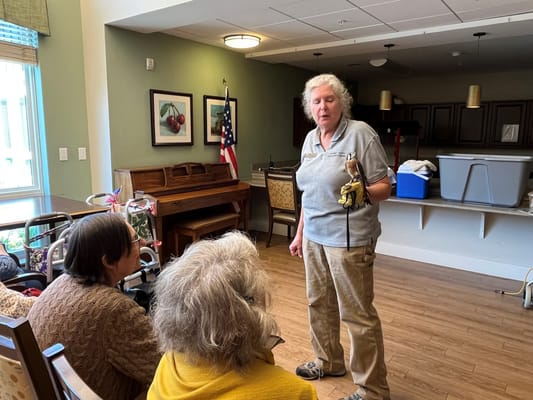 Residents engaged in an activity with staff member