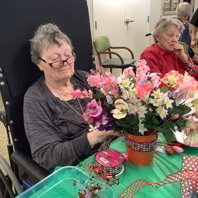 Residents engaging in a floral arrangement activity