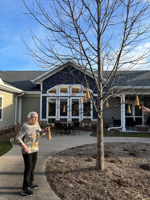 Resident enjoying an outdoor activity by the facility