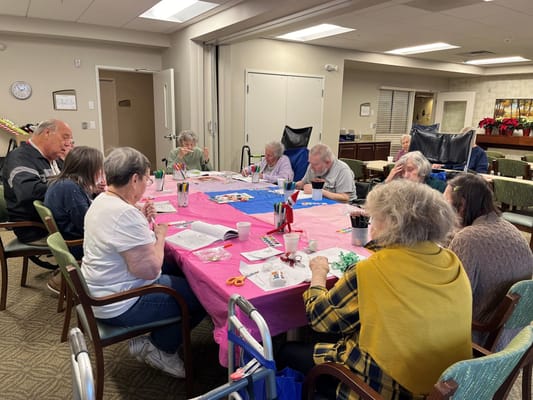 Residents engaged in a crafting activity at a table