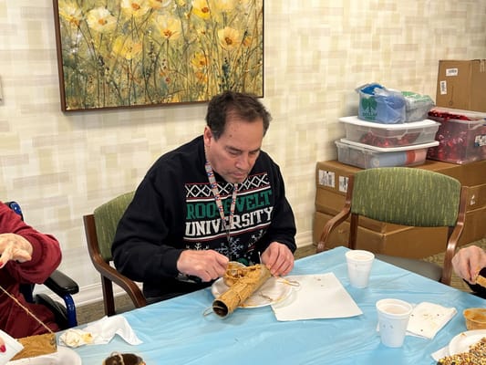 Resident engaged in craft activity inside the facility