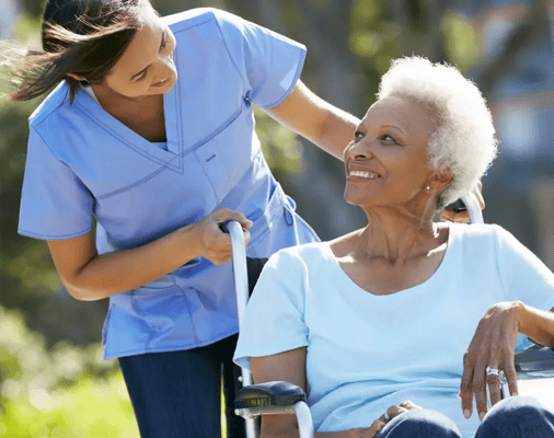Caregiver assisting a resident outdoors