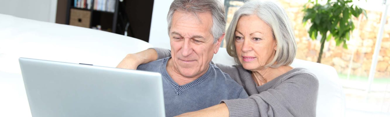 A couple enjoying time on a laptop in a cozy room