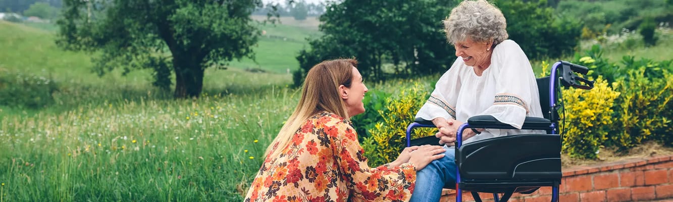 A caregiver talking with a resident outdoors