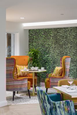 Cozy common area with orange chairs and green wall