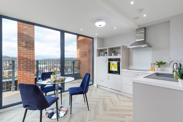 Modern kitchen with table and chairs overlooking a balcony
